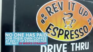 REV IT UP ESPRESSO DRIVE THRU logo with a caption "NO ONE HAS PAID FOR THEIR OWN COFFEE AT REV IT UP ESPRESSO FOR THE PAST 25 WEEKS STRAIGHT