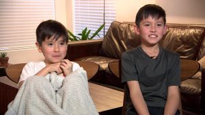 Two cute kids smiling in the living room.